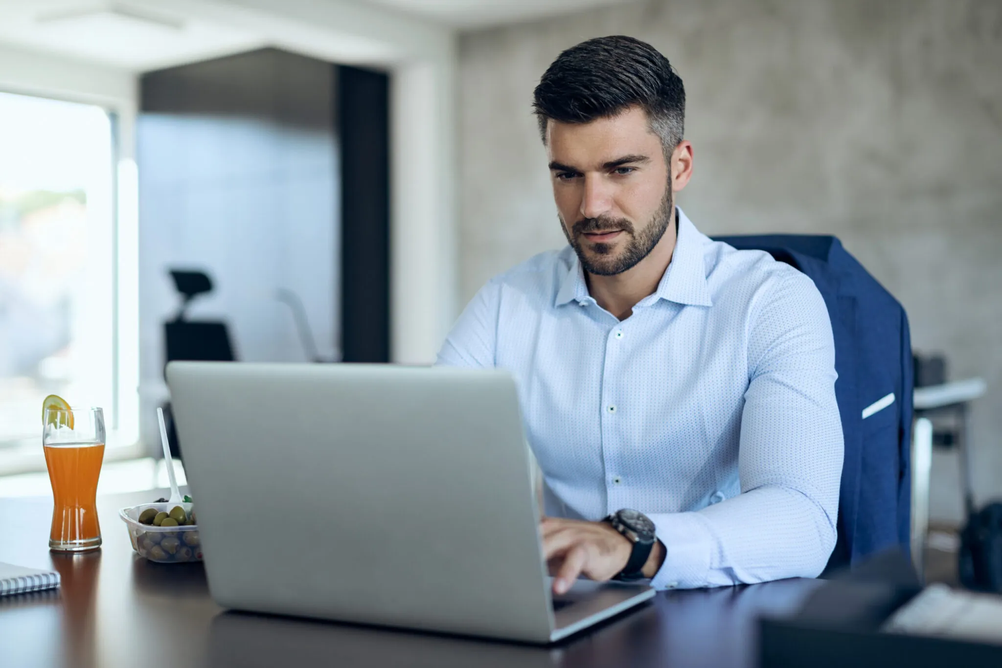 Consultor utilizando notebook em ambiente corporativo